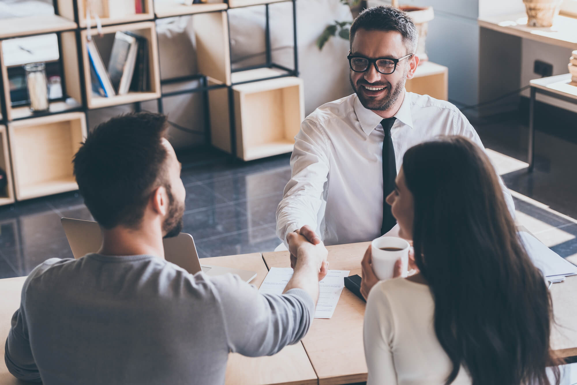 three people talking while discussing about ideas for Profitable Home Business